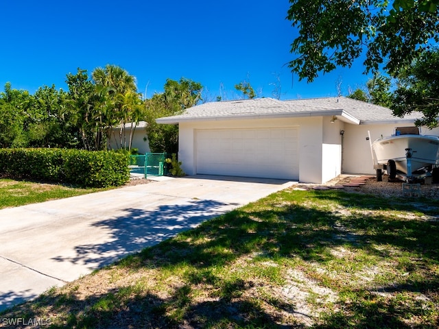 ranch-style home featuring a front lawn and a garage