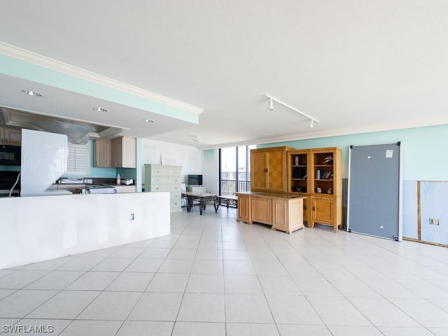 unfurnished living room with crown molding, light tile patterned floors, and track lighting