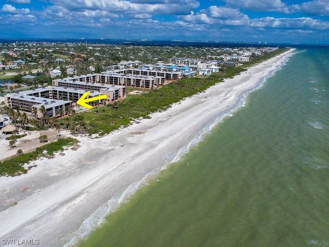 birds eye view of property with a beach view and a water view