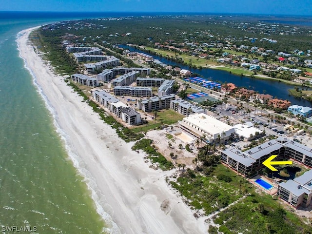 birds eye view of property with a view of the beach and a water view