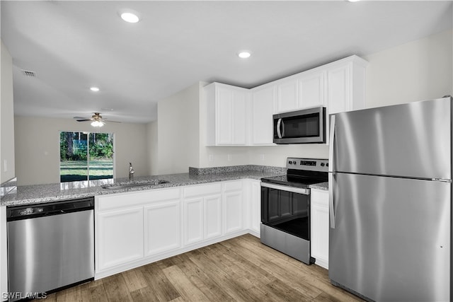 kitchen featuring white cabinetry, ceiling fan, appliances with stainless steel finishes, and kitchen peninsula