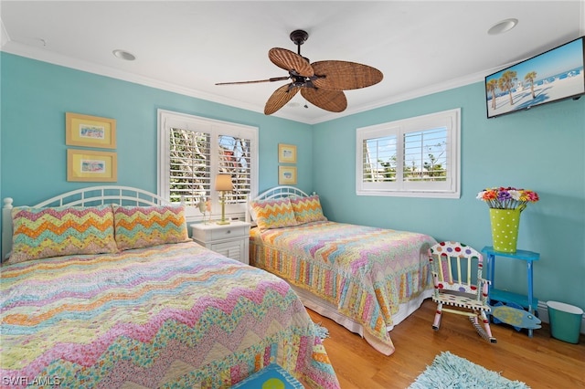 bedroom with crown molding, ceiling fan, and light wood-type flooring