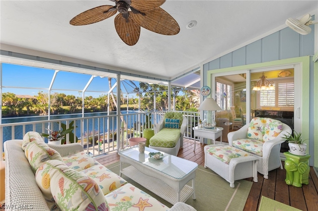 sunroom featuring vaulted ceiling and ceiling fan with notable chandelier