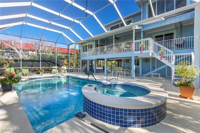 view of pool featuring an in ground hot tub, a lanai, and a patio area