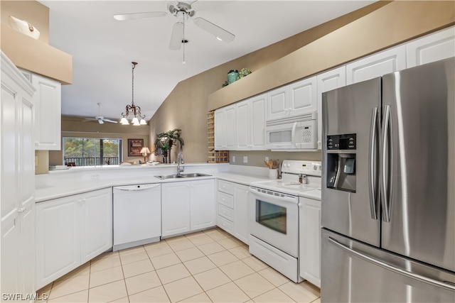 kitchen with white appliances, sink, hanging light fixtures, white cabinets, and ceiling fan with notable chandelier