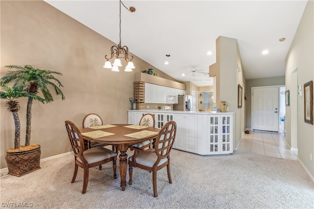 dining area featuring light carpet, high vaulted ceiling, and ceiling fan with notable chandelier