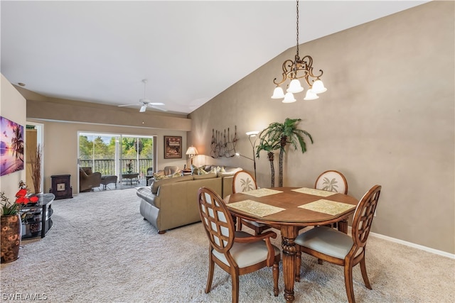 dining area with light carpet, ceiling fan with notable chandelier, and vaulted ceiling