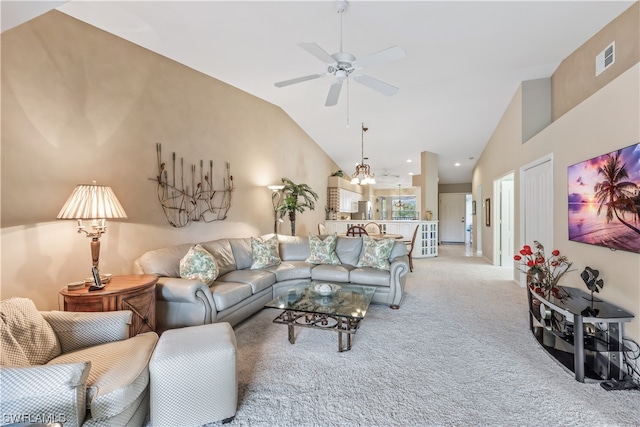 living room featuring light carpet, ceiling fan with notable chandelier, and lofted ceiling