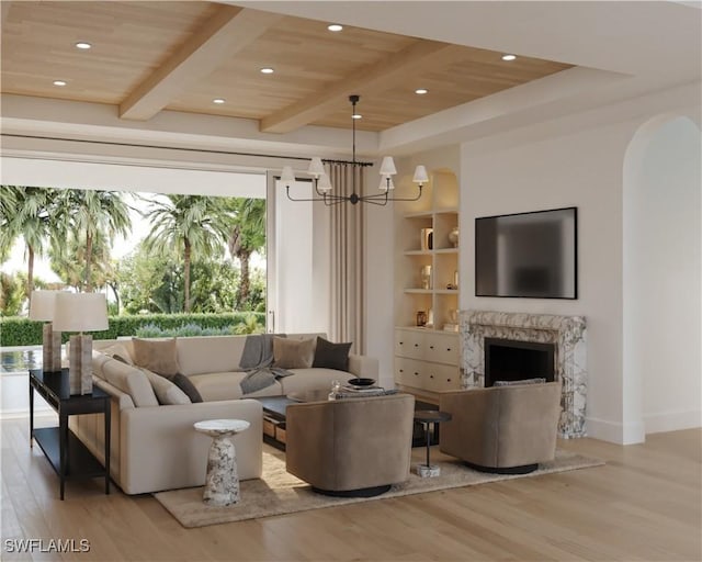 living room with a fireplace, wooden ceiling, light hardwood / wood-style floors, and a chandelier