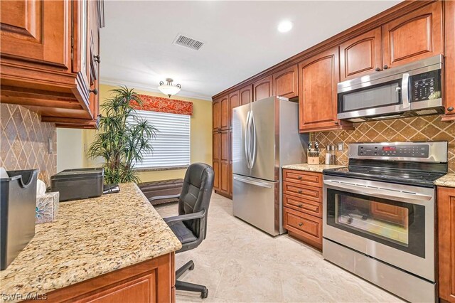 kitchen featuring appliances with stainless steel finishes, tasteful backsplash, light stone counters, and ornamental molding