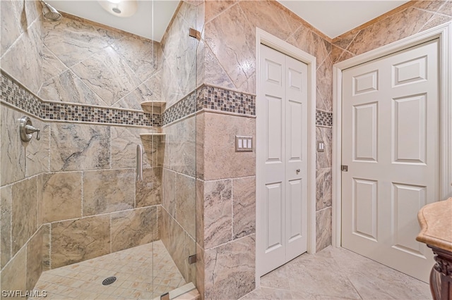 bathroom featuring a shower with door and tile walls