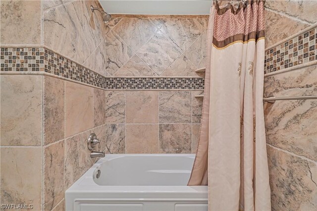 bathroom with shower / bath combo with shower curtain