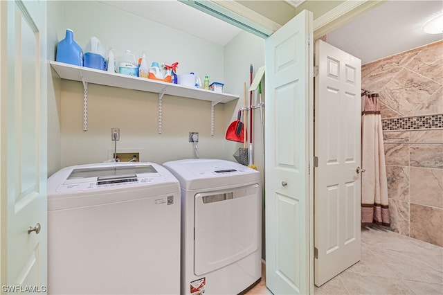 laundry room featuring washer and dryer and light tile patterned flooring