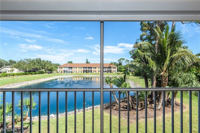 view of swimming pool with a lawn and a water view