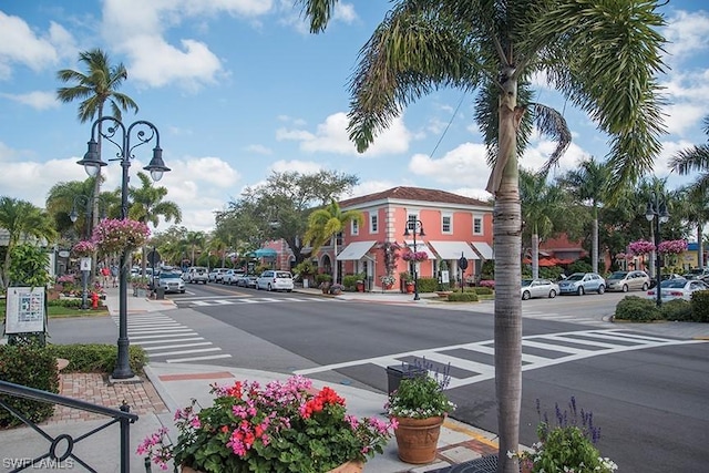 view of road featuring sidewalks, curbs, and street lights