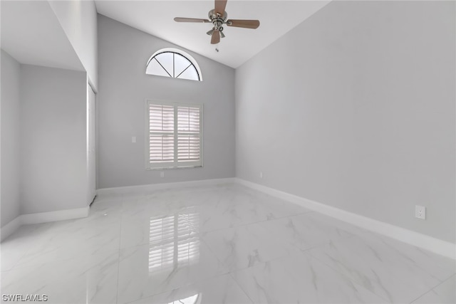 spare room with high vaulted ceiling, ceiling fan, and light tile floors