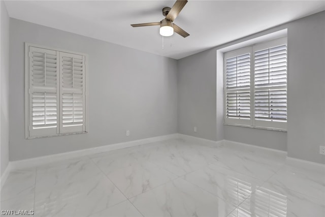 tiled spare room featuring ceiling fan