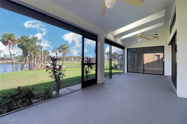 unfurnished sunroom featuring a water view, ceiling fan, and lofted ceiling