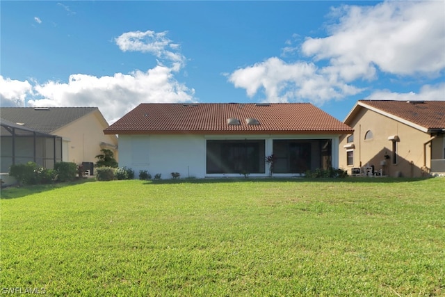 back of property featuring a yard