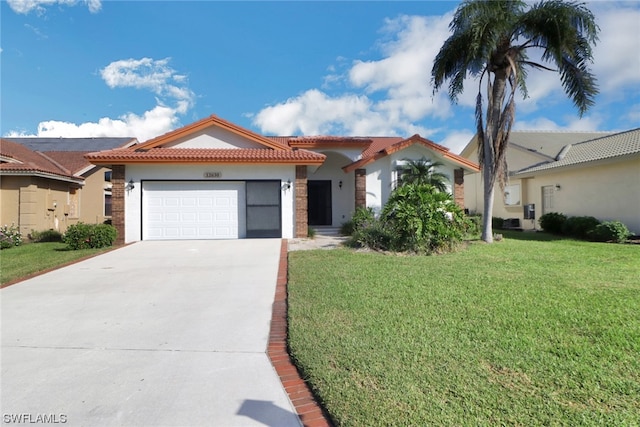 mediterranean / spanish house with a front lawn and a garage