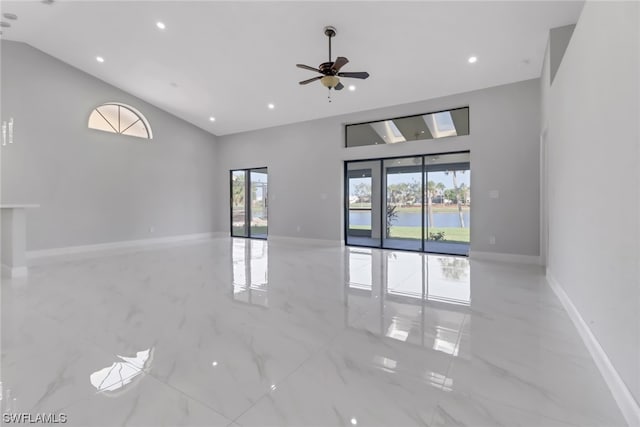 unfurnished room featuring ceiling fan, light tile floors, and high vaulted ceiling