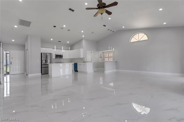 interior space featuring light tile flooring, sink, ceiling fan, and high vaulted ceiling