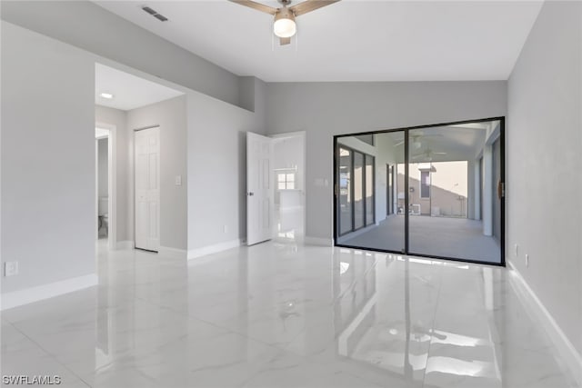 tiled spare room featuring ceiling fan and vaulted ceiling