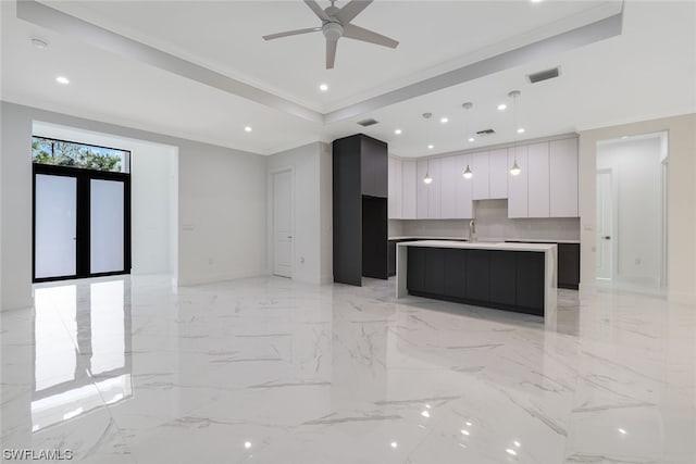 interior space featuring a raised ceiling, light tile flooring, and ornamental molding