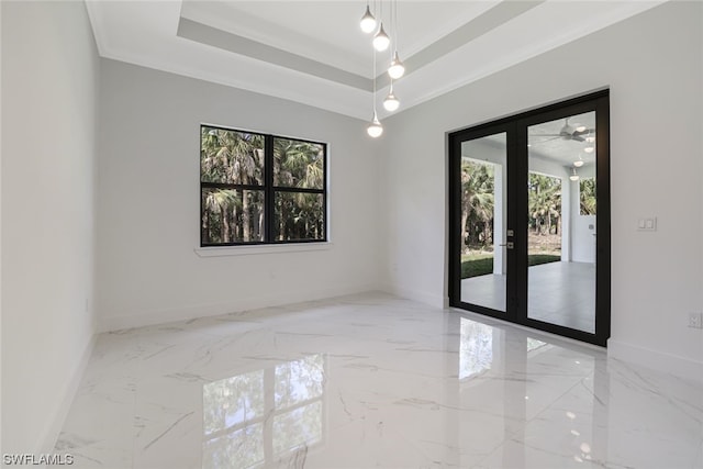 spare room with light tile floors, ceiling fan, french doors, crown molding, and a raised ceiling