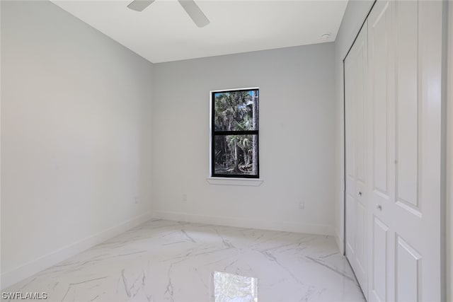 tiled empty room with ceiling fan