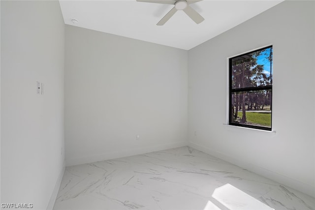 tiled spare room with ceiling fan