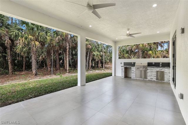 view of patio featuring a grill, an outdoor kitchen, and ceiling fan