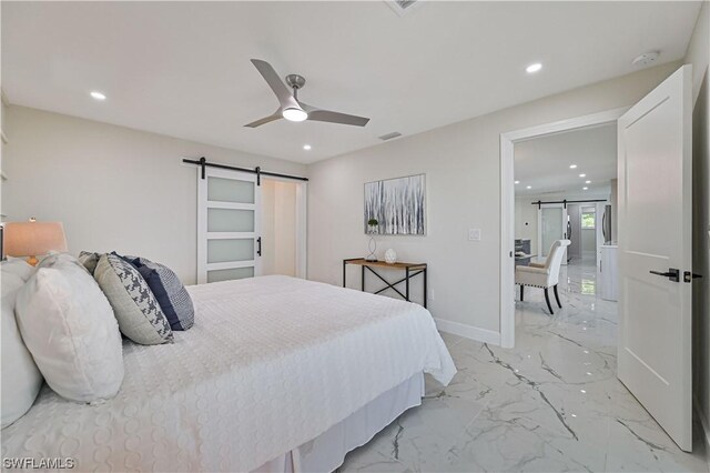 bedroom with a barn door and ceiling fan