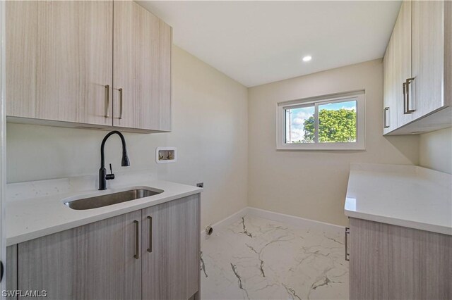 laundry room with hookup for an electric dryer, hookup for a washing machine, cabinets, and sink