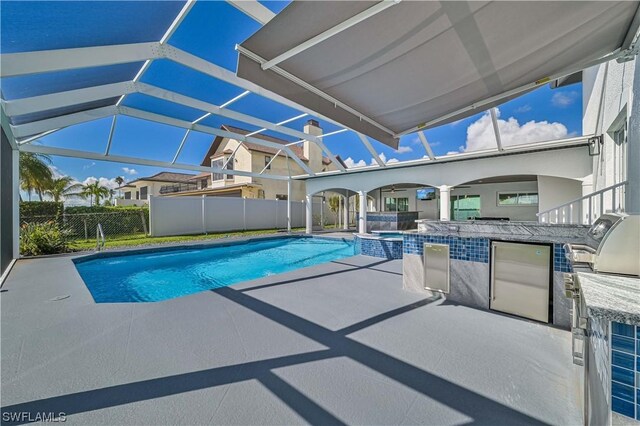 view of pool featuring a lanai, a patio area, and an in ground hot tub