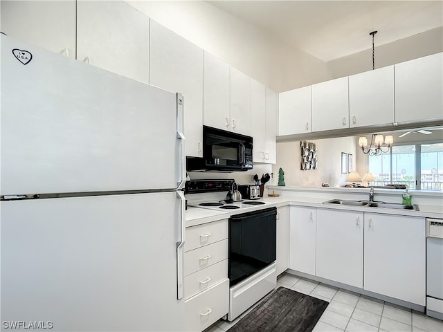 kitchen with a chandelier, light tile floors, white appliances, and white cabinetry