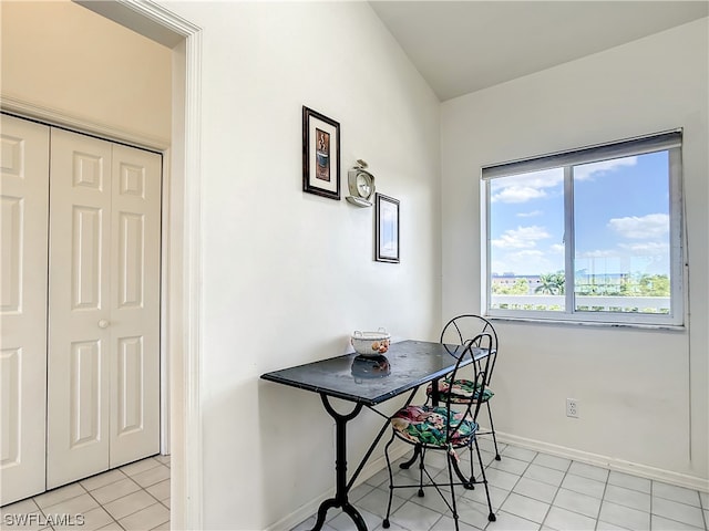 dining space featuring light tile flooring