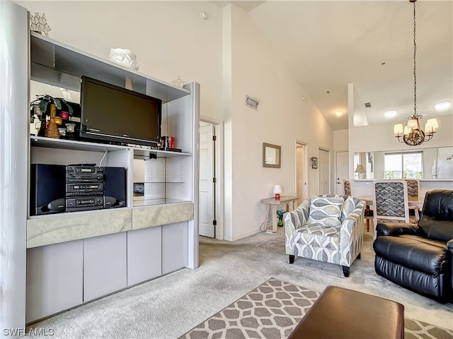 living room featuring an inviting chandelier, light carpet, and high vaulted ceiling