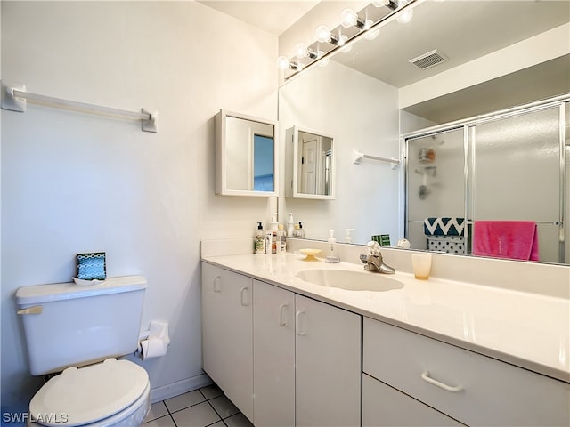 bathroom featuring toilet, tile floors, and vanity