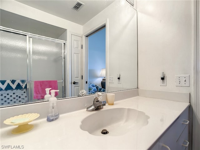 bathroom featuring an enclosed shower and vanity