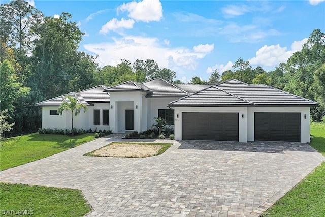 view of front of property with a front lawn and a garage