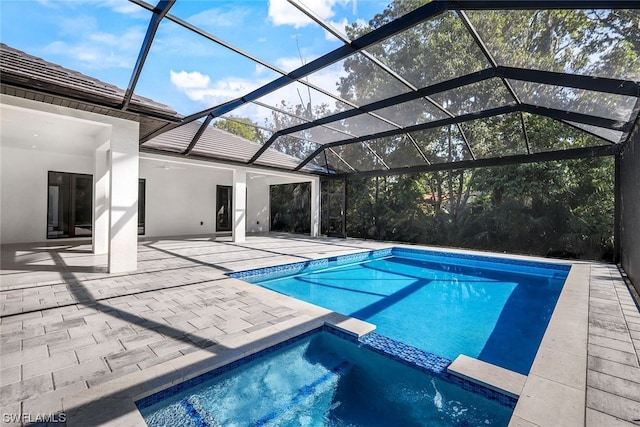 view of swimming pool featuring a patio area and a lanai