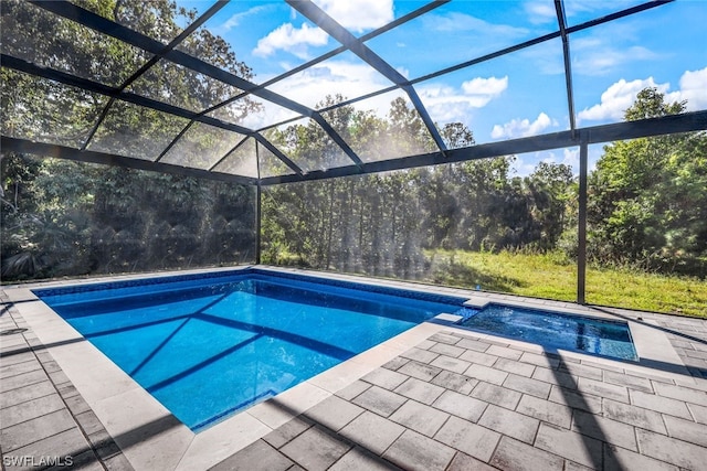 view of swimming pool with a patio and a lanai