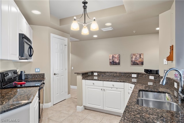 kitchen featuring pendant lighting, light tile floors, sink, range with electric stovetop, and a chandelier