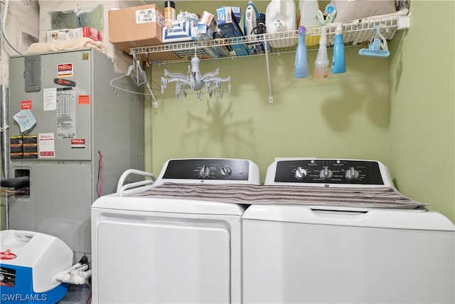 laundry area with heating utilities and washing machine and dryer