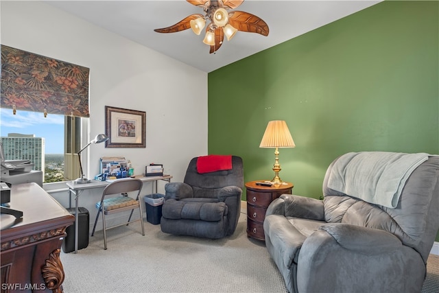 carpeted office space featuring ceiling fan