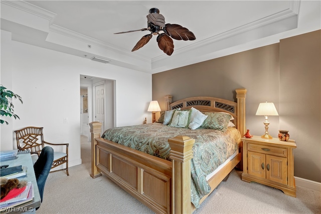 carpeted bedroom with ceiling fan, crown molding, and a raised ceiling