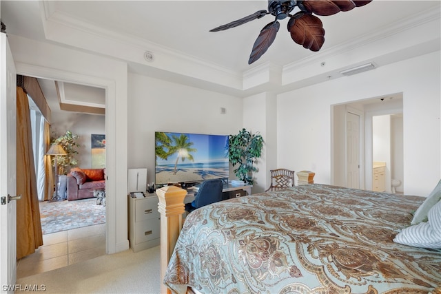 carpeted bedroom featuring ensuite bathroom, ornamental molding, ceiling fan, and a tray ceiling