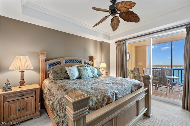 carpeted bedroom featuring a tray ceiling, ceiling fan, ornamental molding, and access to outside