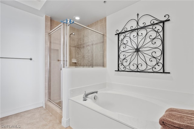 bathroom featuring tile flooring and separate shower and tub